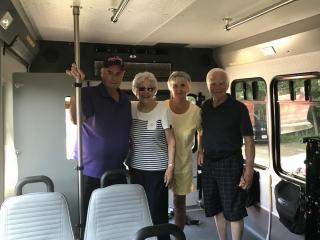 A photo of four seniors exploring a handicap accessible bus.