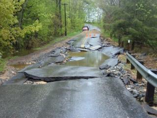 A photo of a road made impassable by water damage resulting from culvert overflow